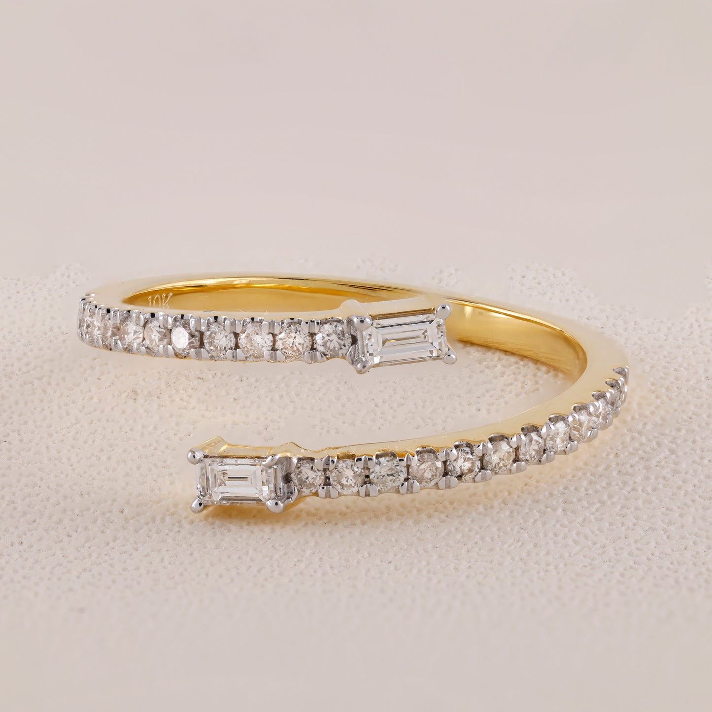 Gold bracelet with diamond accents on a light gray background