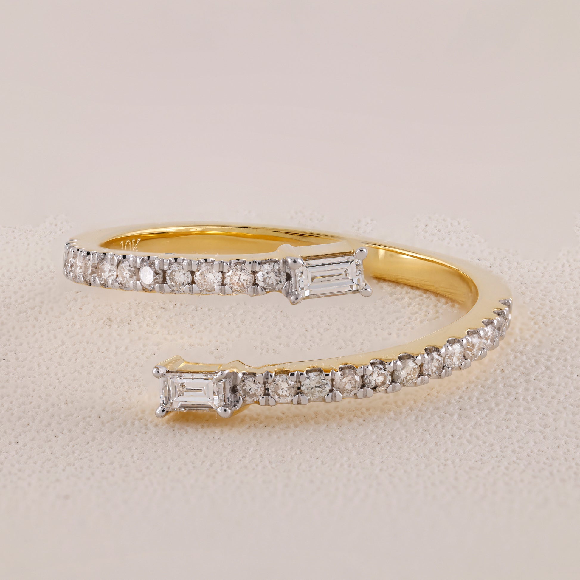 Gold bracelet with diamond accents on a light gray background