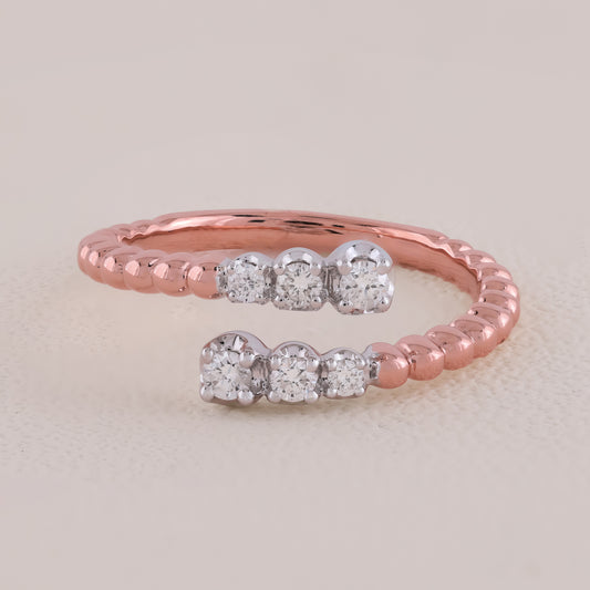 Rose gold ring with diamond accents on a light beige background