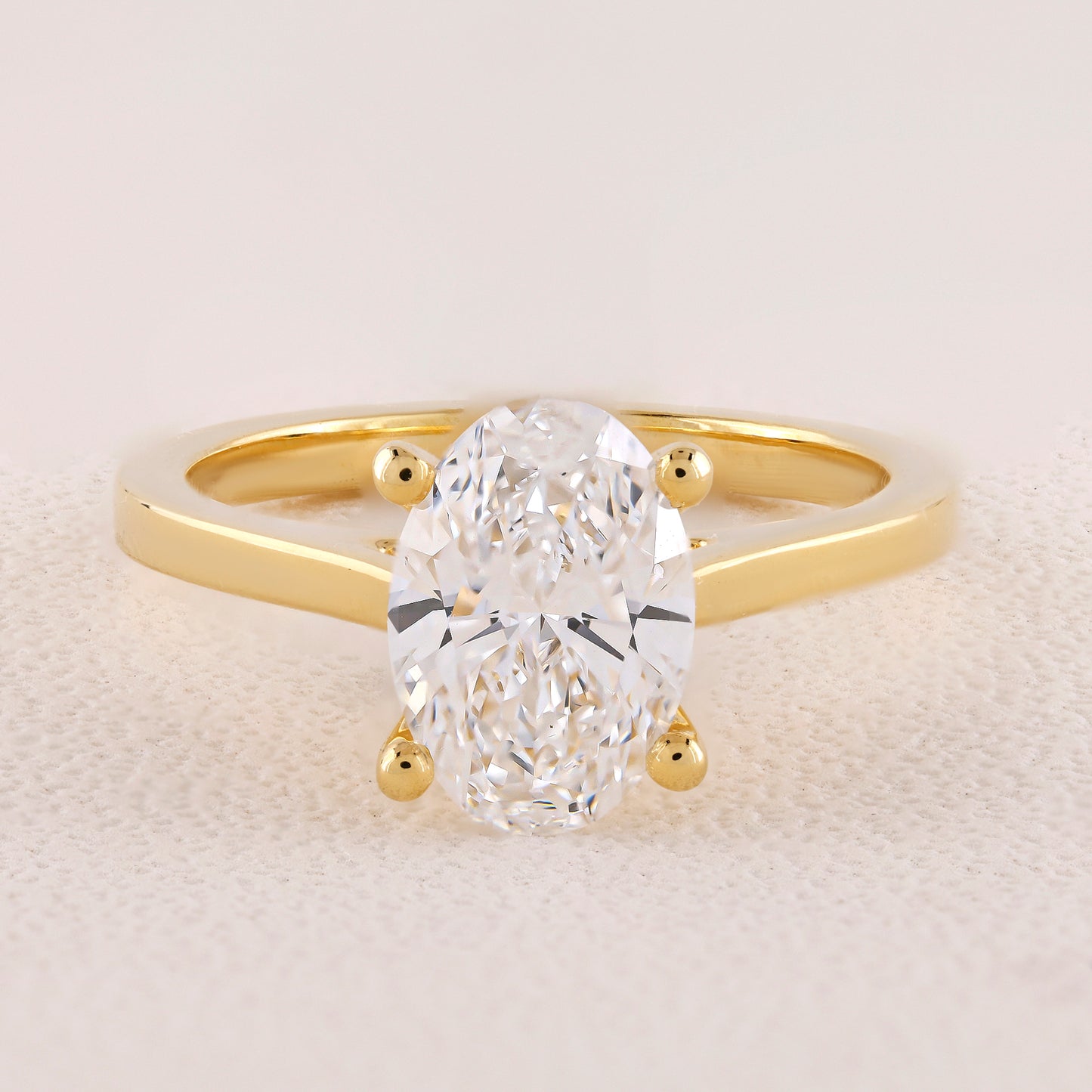 Gold ring with a large diamond on a light background