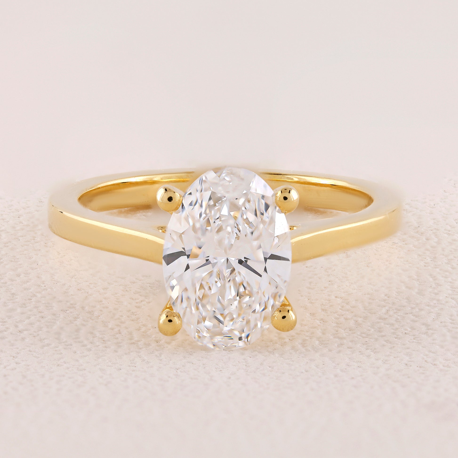 Gold ring with a large diamond on a light background