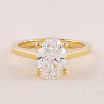 Gold ring with a large diamond on a light background