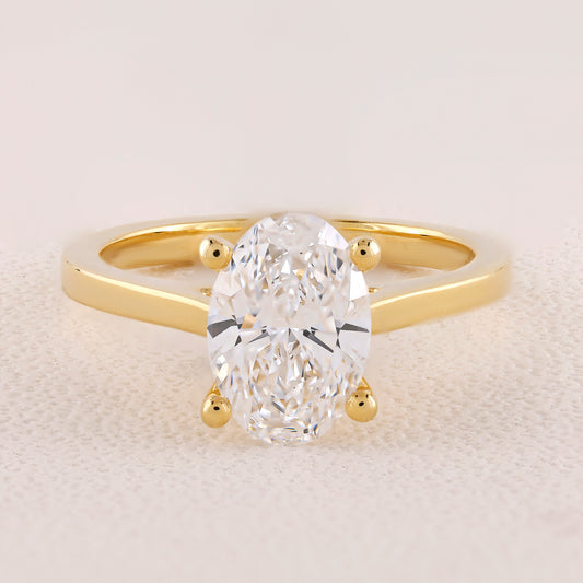Gold ring with a large diamond on a light background