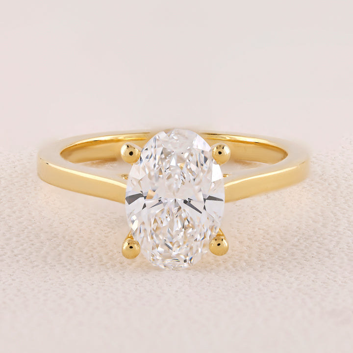 Gold ring with a large diamond on a light background