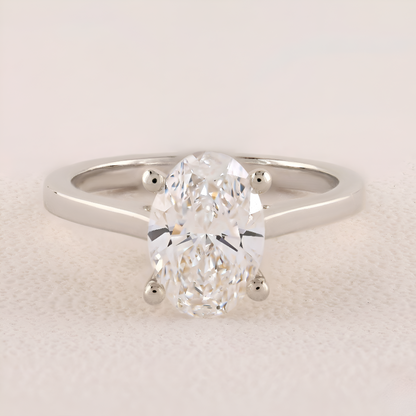 Diamond ring with a pear-shaped center stone on a light background