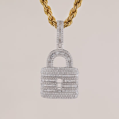 Diamond-encrusted lock-shaped pendant on a gold chain against a light gray background