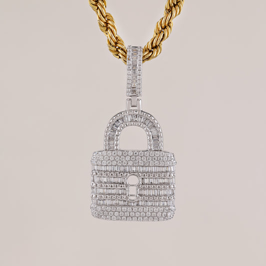 Diamond-encrusted lock-shaped pendant on a gold chain against a light gray background