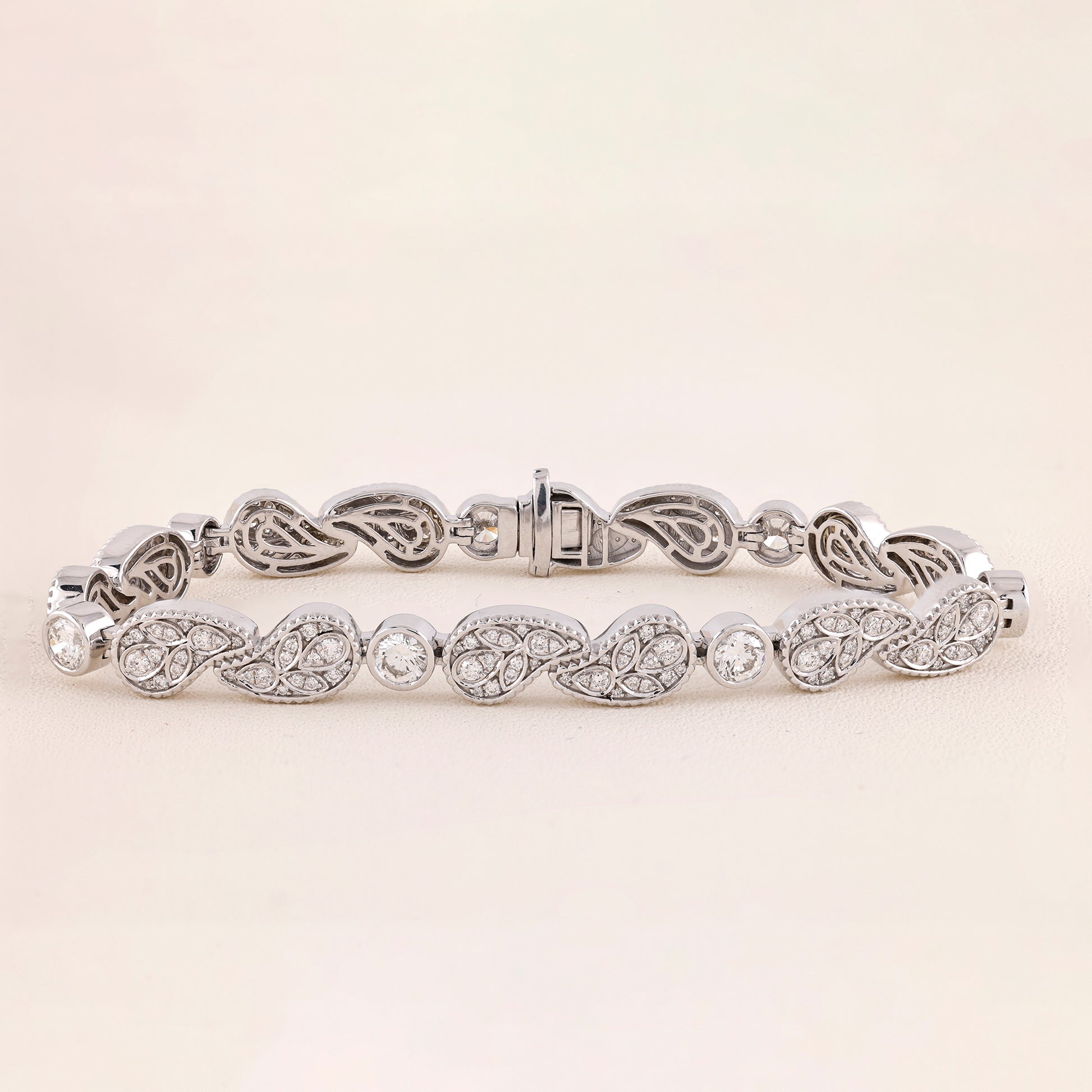 White Gold bracelet with intricate design on a light beige background