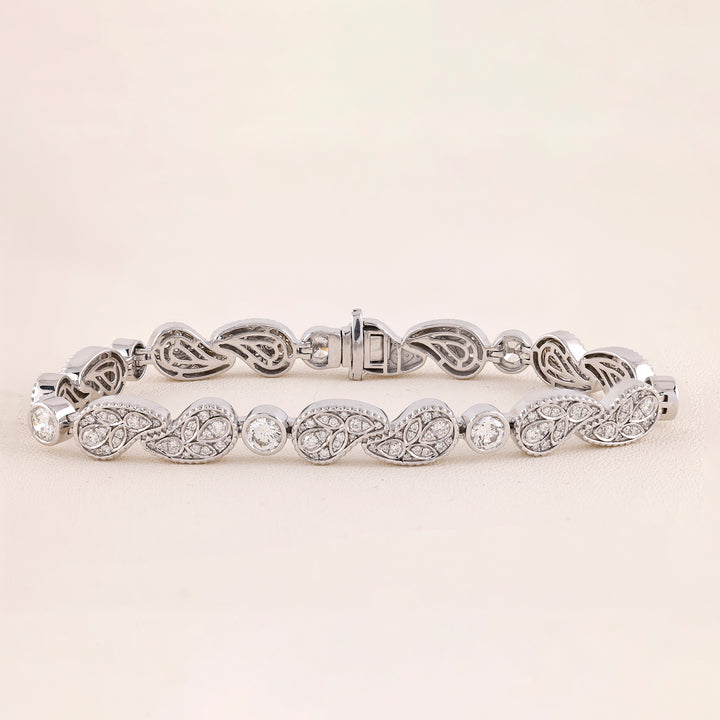 White Gold bracelet with intricate design on a light beige background