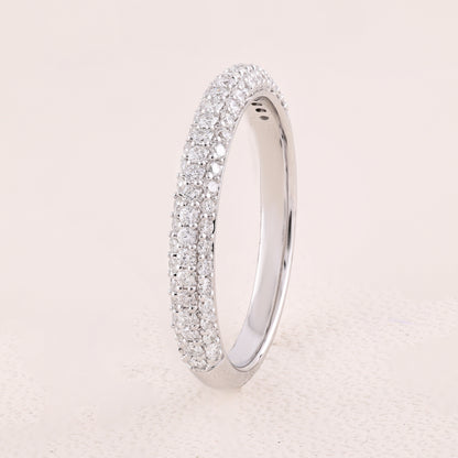 Silver ring with diamond accents on a light beige background