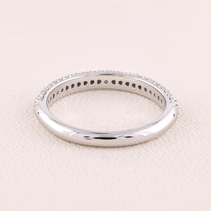 Silver ring with small stones on a light beige background