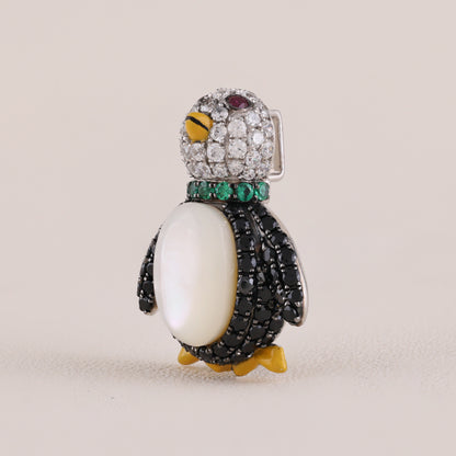 Jeweled penguin brooch on a beige background