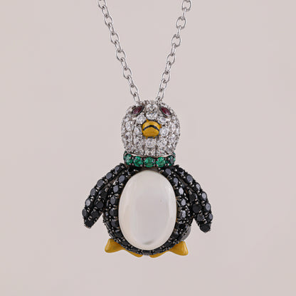 Penguin-shaped necklace with gemstones on a light gray background