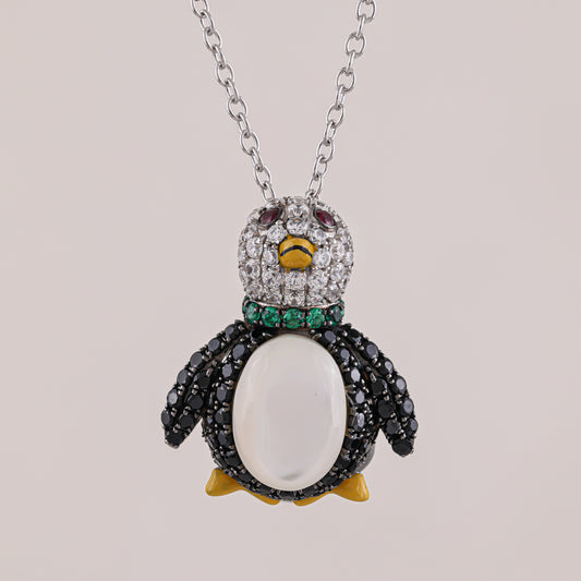 Penguin-shaped necklace with gemstones on a light gray background