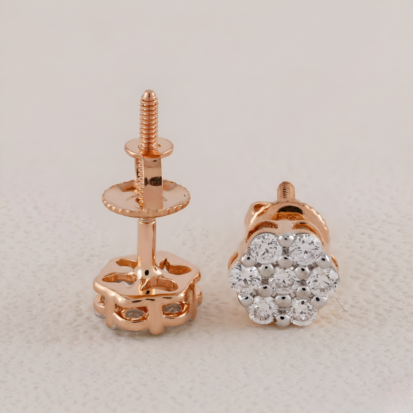 Rose gold earring with clear gemstones on a light gray background