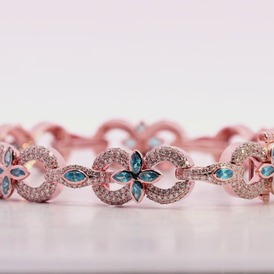 Rose gold bracelet with blue gemstones on a light beige background Video