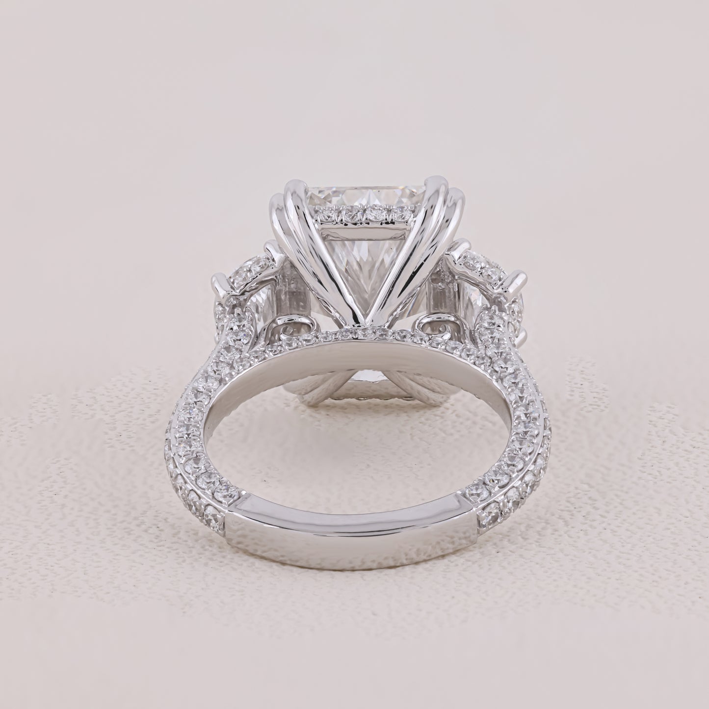 Diamond ring with a clear gemstone on a light beige background
