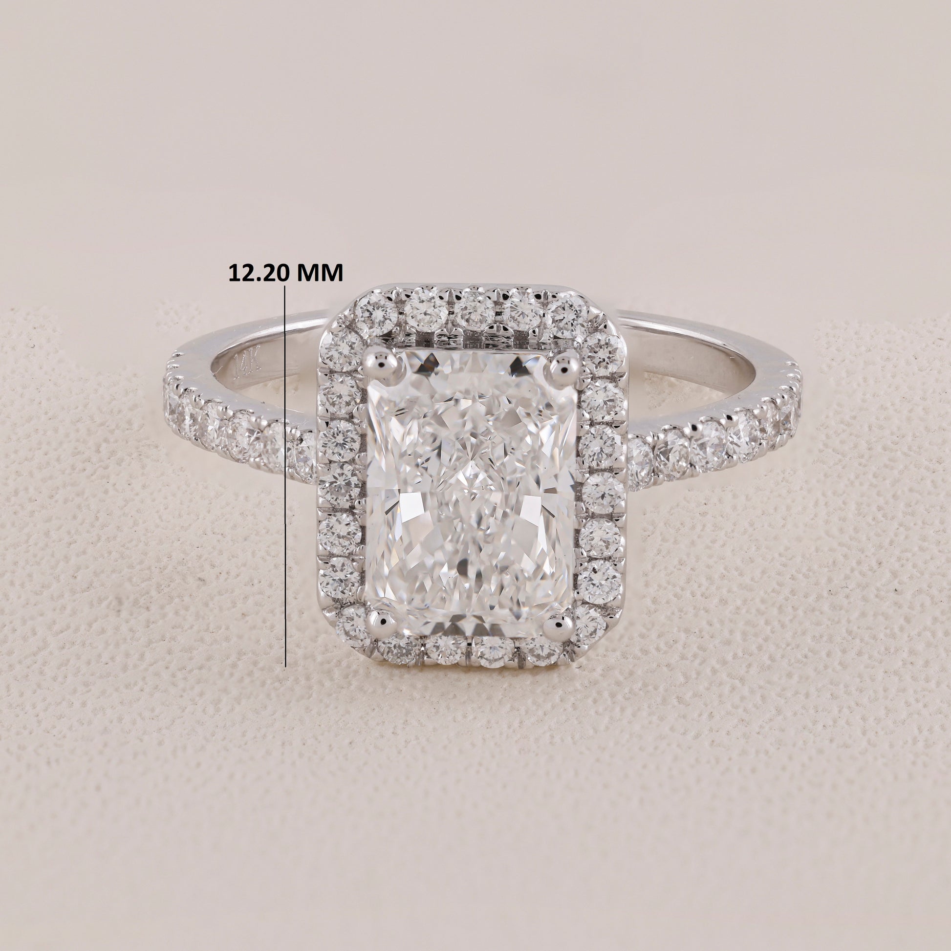 Diamond ring with a measurement label on a light gray background