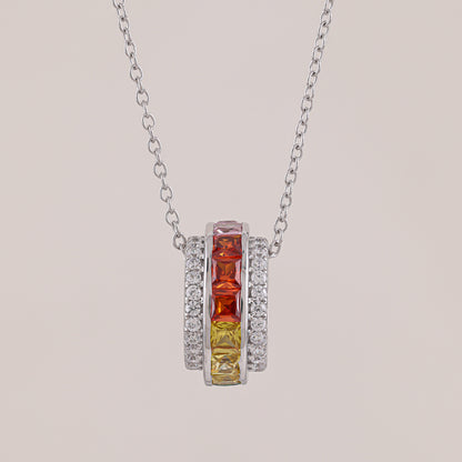 Necklace with a pendant featuring red and yellow gemstones on a light gray background