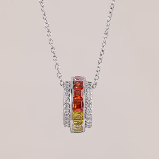 Necklace with a pendant featuring red and yellow gemstones on a light gray background