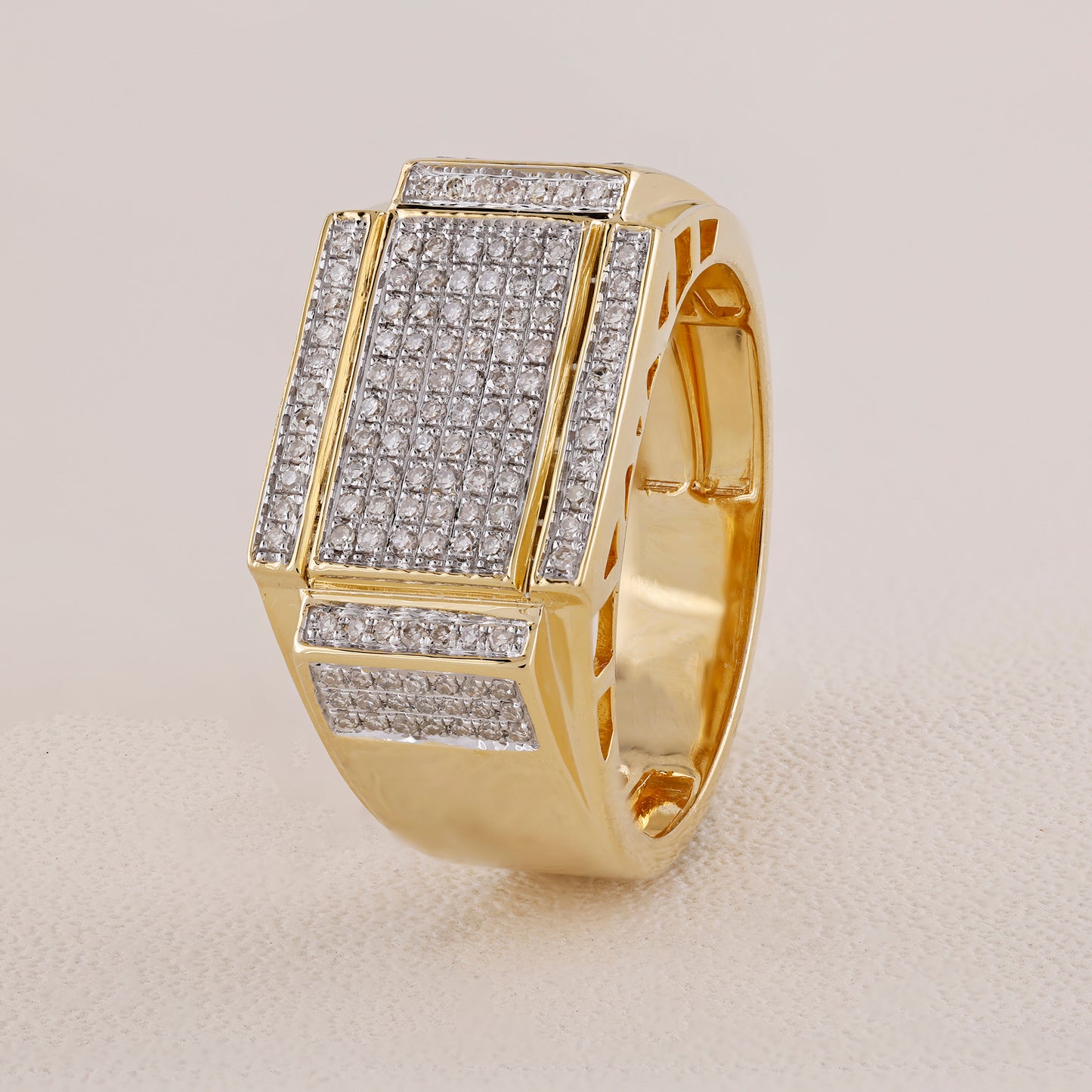 Gold ring with diamond accents on a light gray background