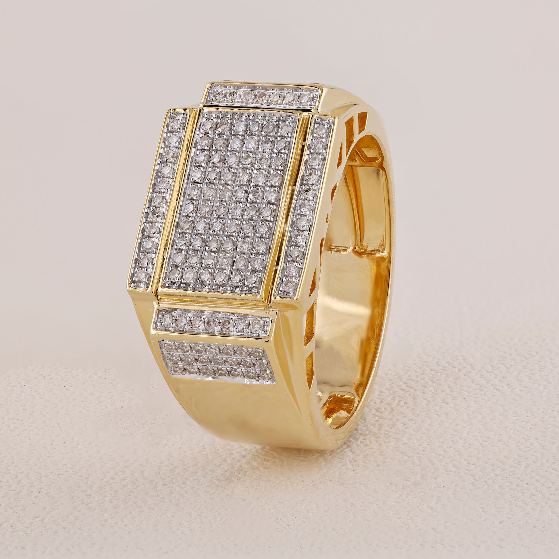 Gold ring with diamond accents on a light gray background
