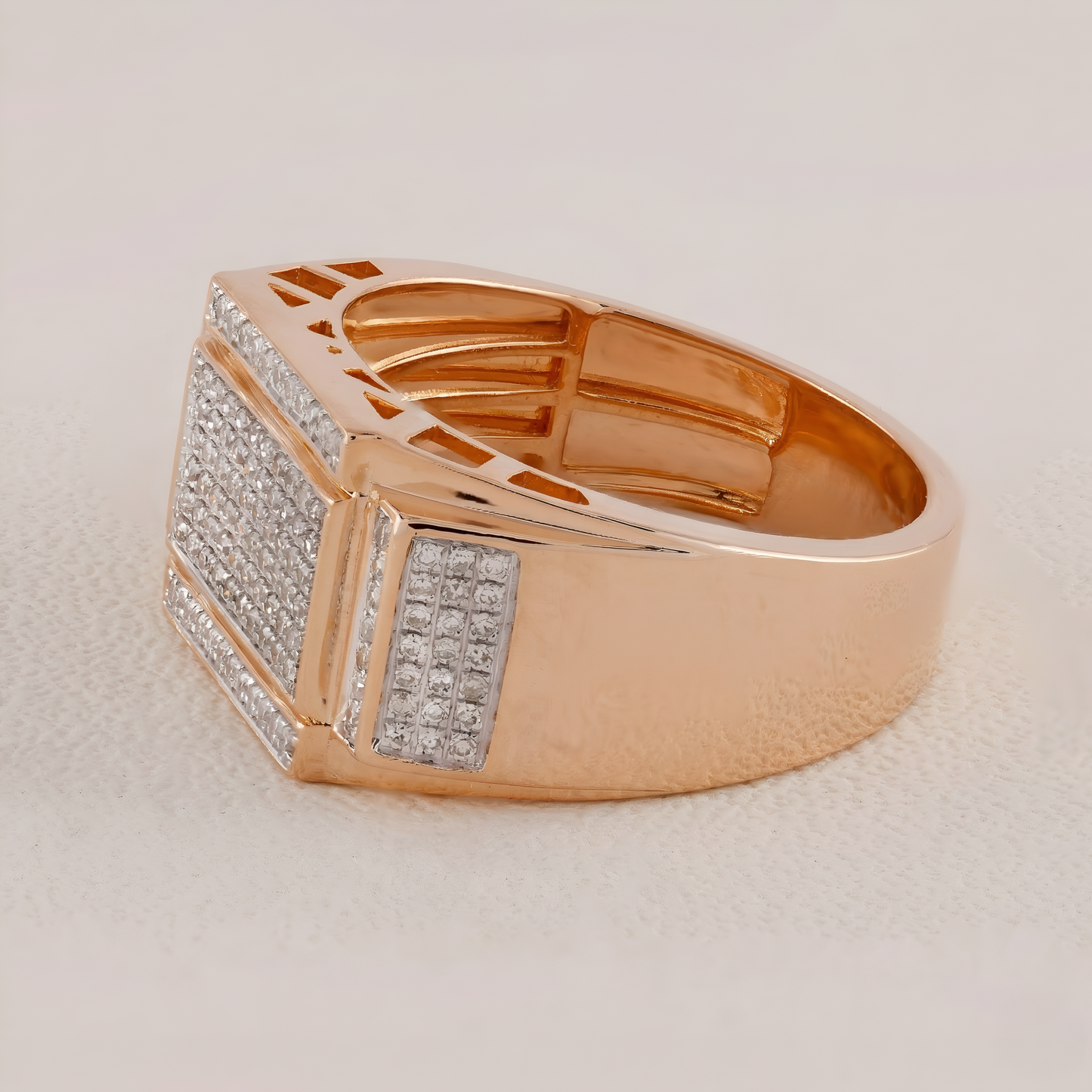 Rose gold ring with diamond accents on a light beige background