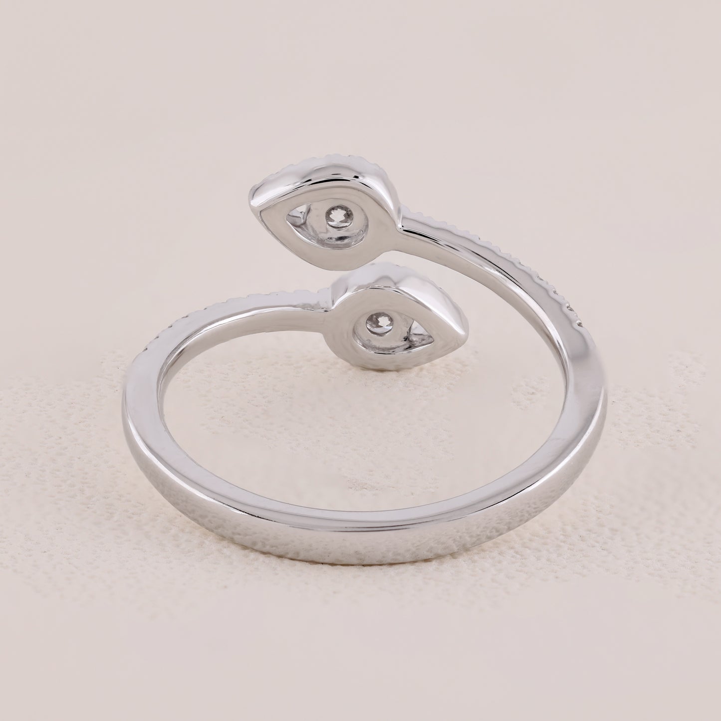 Silver ring with a unique design on a light beige background