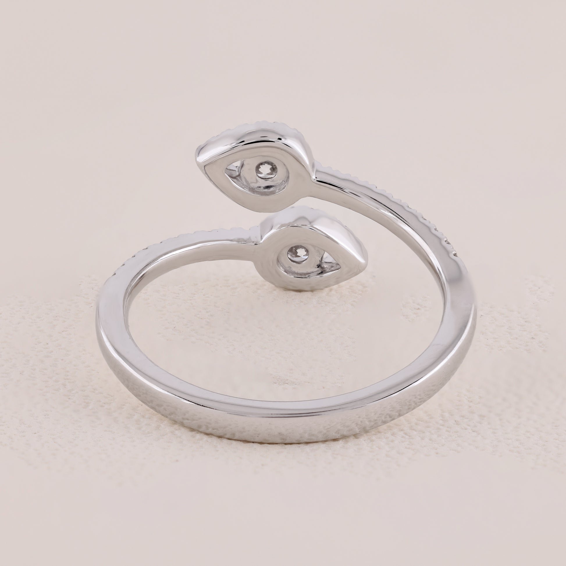 Silver ring with a unique design on a light beige background