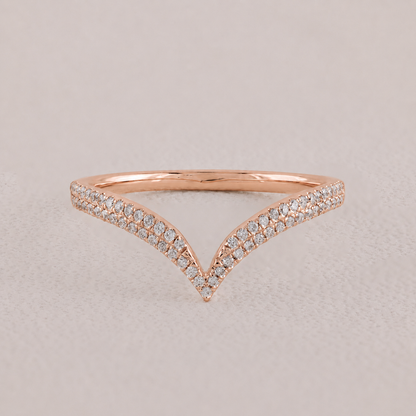 Rose gold ring with diamond accents on a light gray background