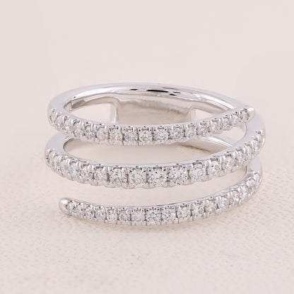 Two diamond-studded silver rings on a light beige background