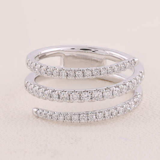 Two diamond-studded silver rings on a light beige background