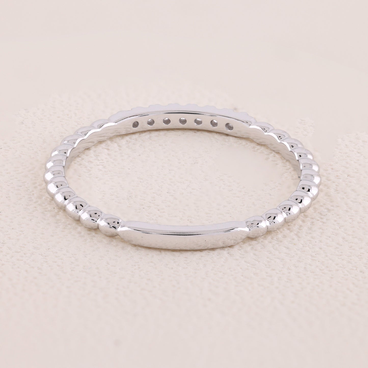Silver bracelet on a beige background