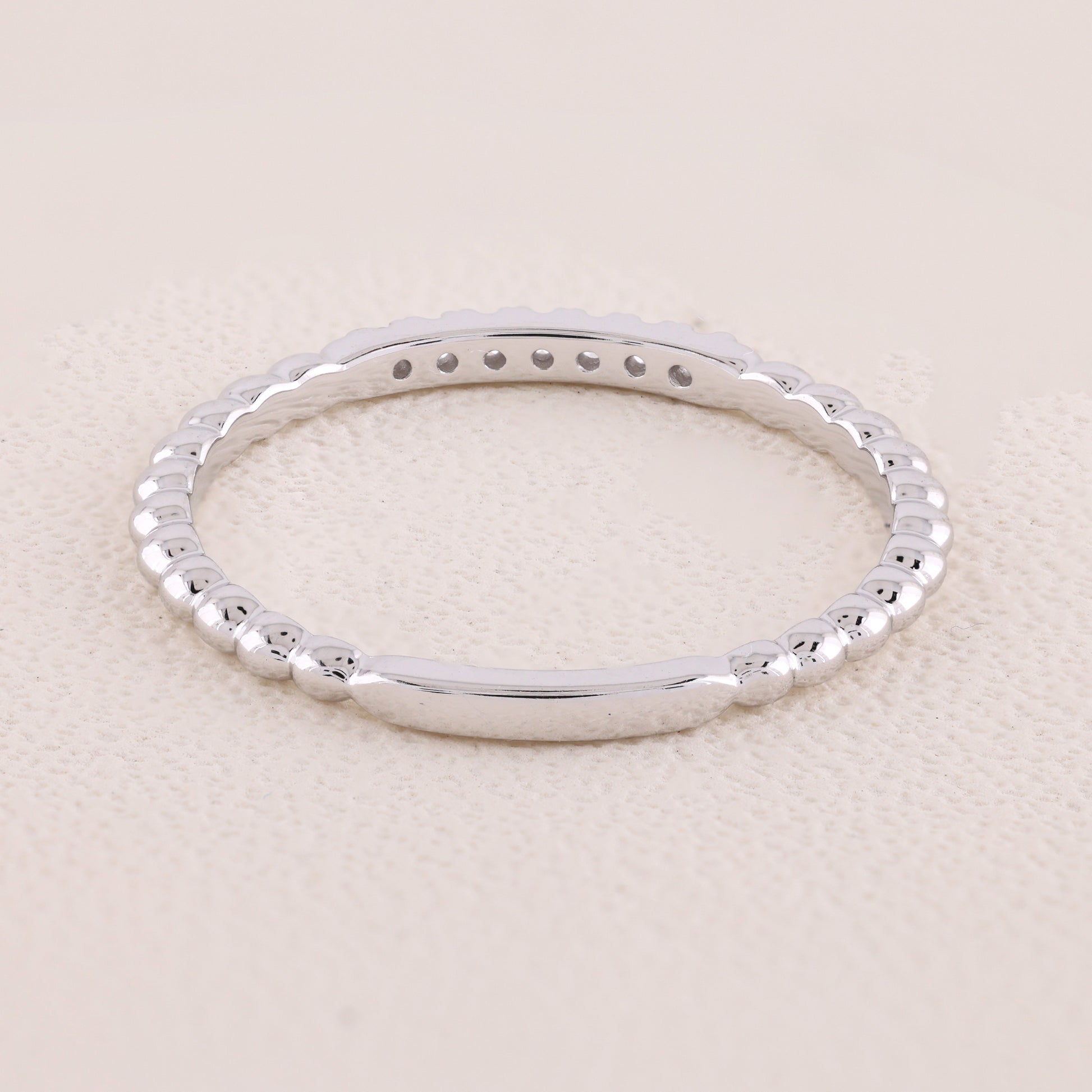 Silver bracelet on a beige background