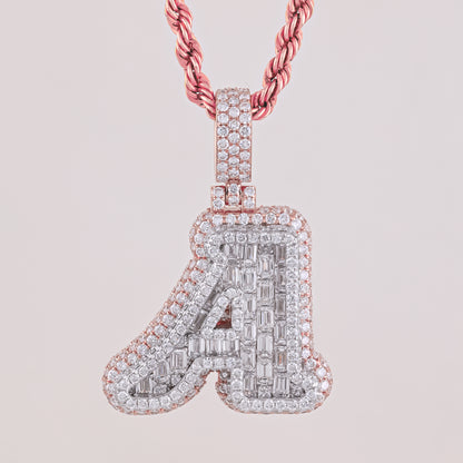 Diamond-studded letter 'A' pendant on a pink chain against a light pink background