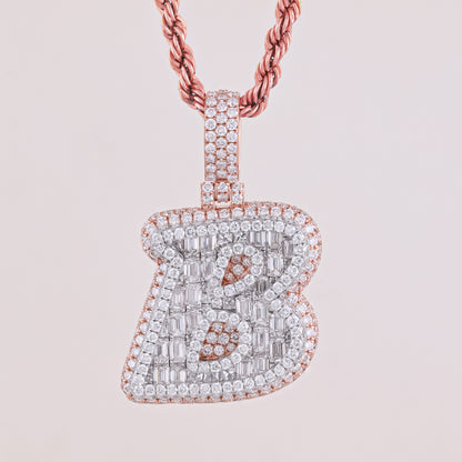 Diamond-encrusted letter 'B' pendant on a pink background