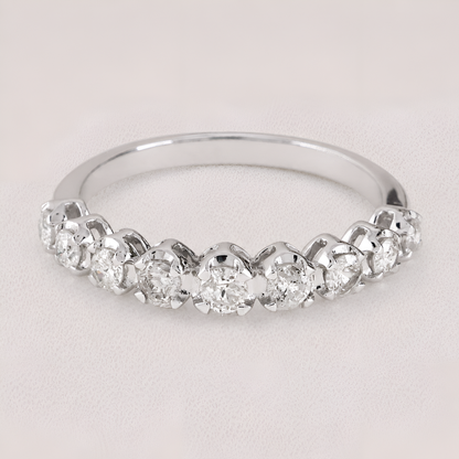 A silver-toned diamond band ring featuring a row of round-cut diamonds set in a half-circle arrangement, photographed on a light neutral background.