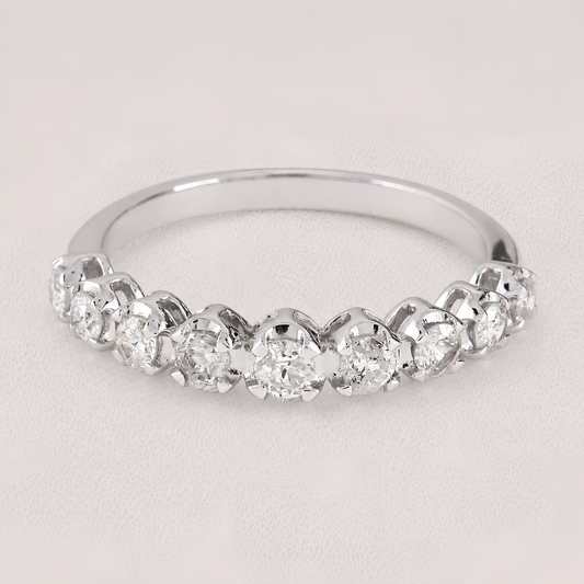 A silver-toned diamond band ring featuring a row of round-cut diamonds set in a half-circle arrangement, photographed on a light neutral background.