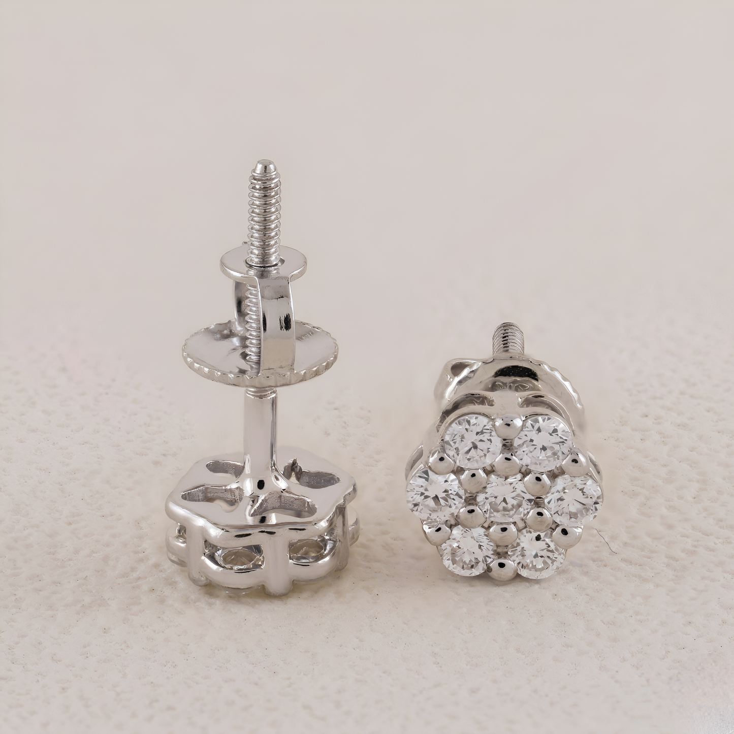 Silver stud earrings with clear gemstones on a light gray background