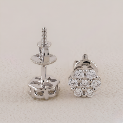 Silver stud earrings with clear gemstones on a light gray background