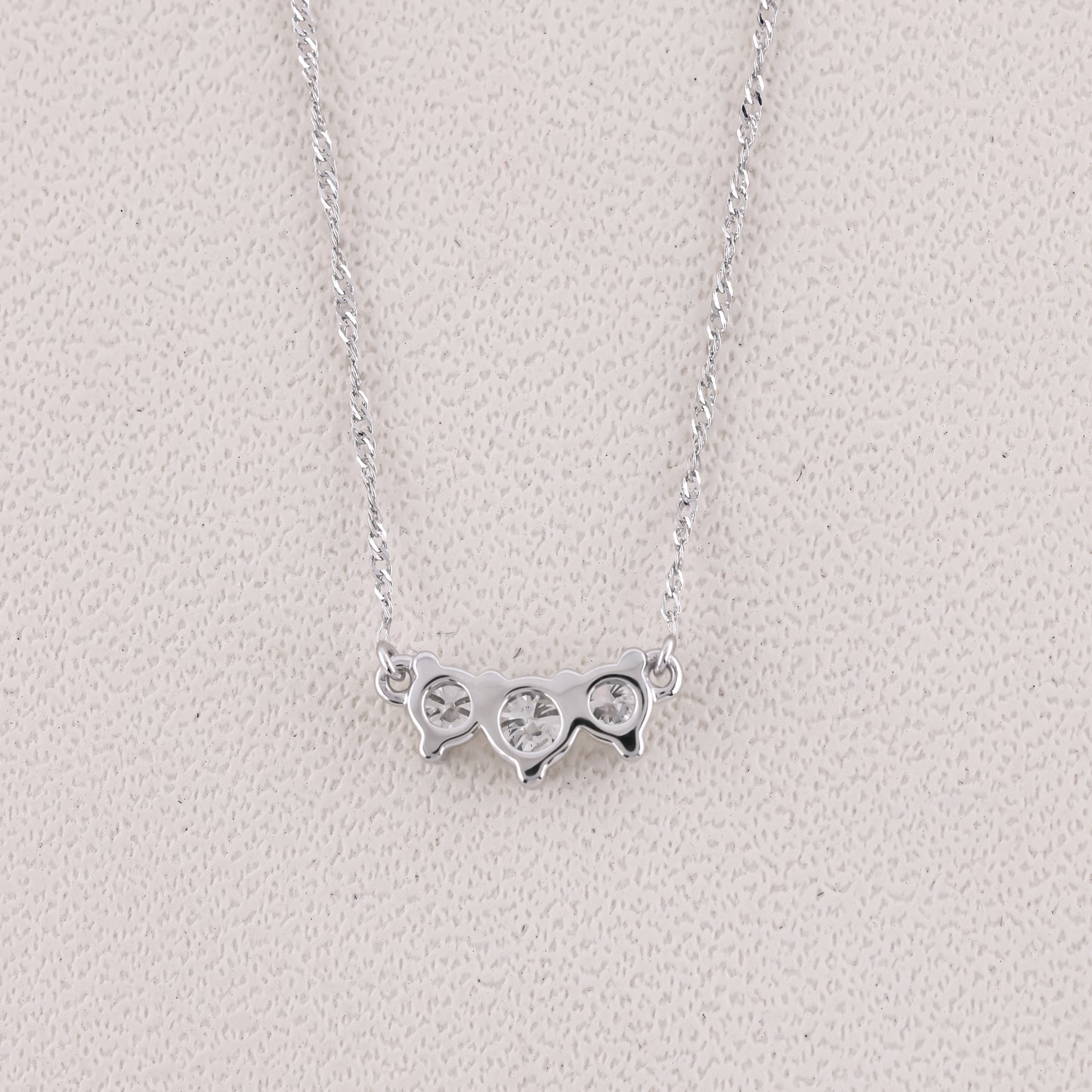 Silver necklace with a unique pendant on a light gray background