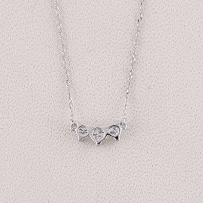 Silver necklace with a unique pendant on a light gray background