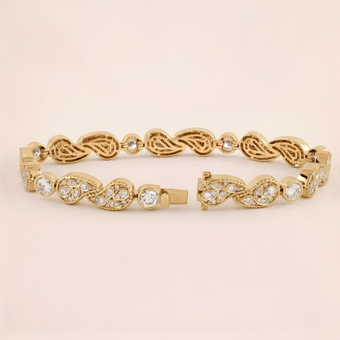 Gold bracelet with intricate design on a beige background