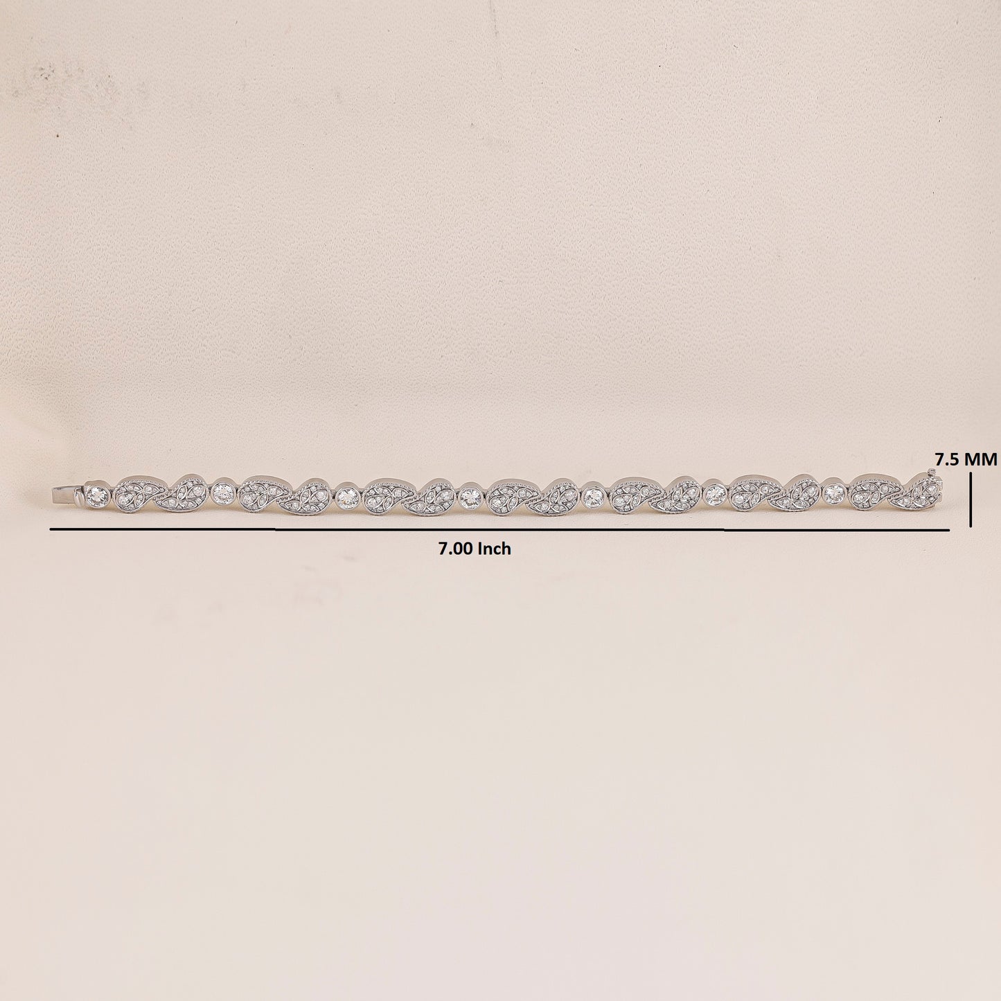 White Gold hair barrette with clear stones on a beige background, showing measurements.