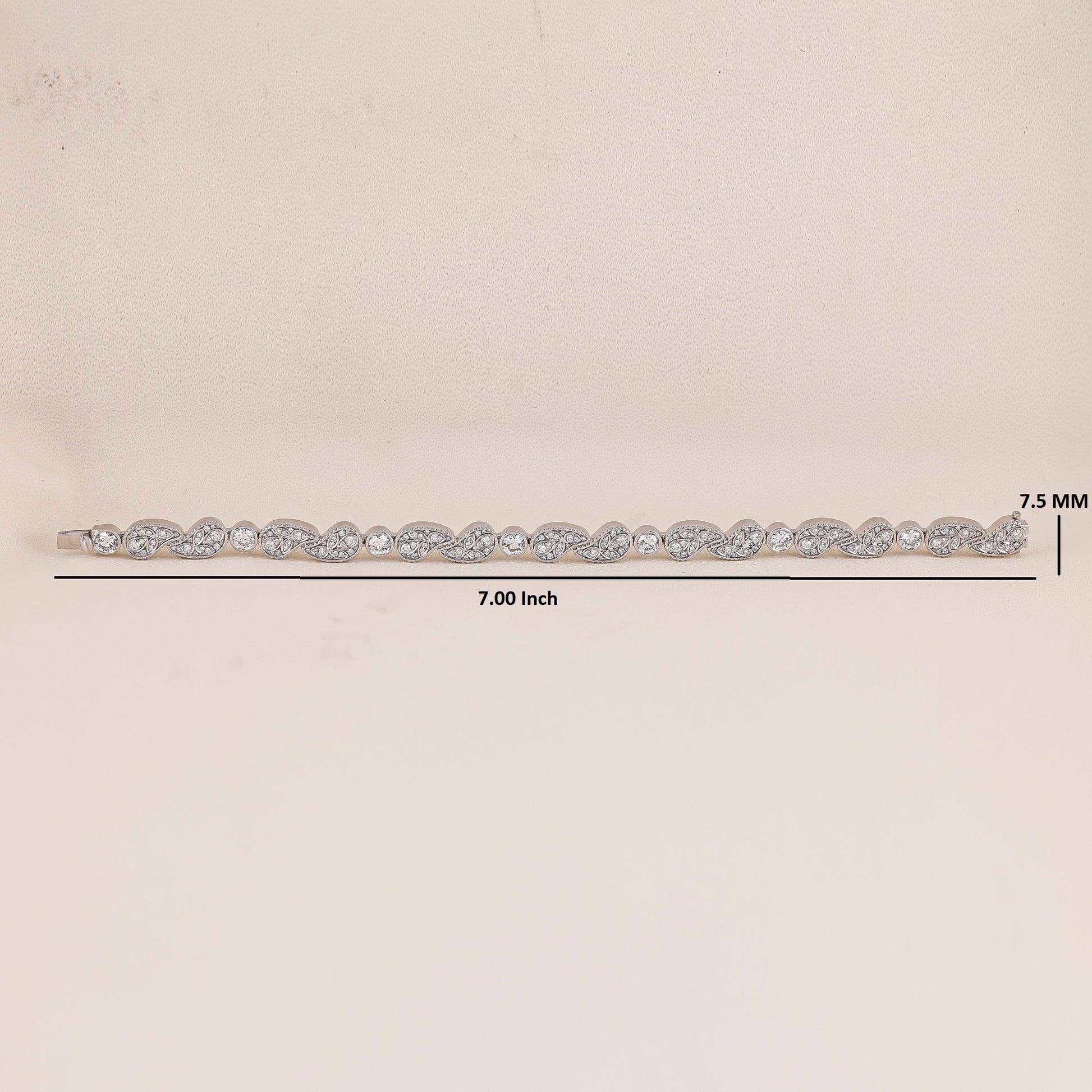 White Gold hair barrette with clear stones on a beige background, showing measurements.