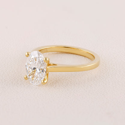 Gold ring with a large diamond on a light beige background
