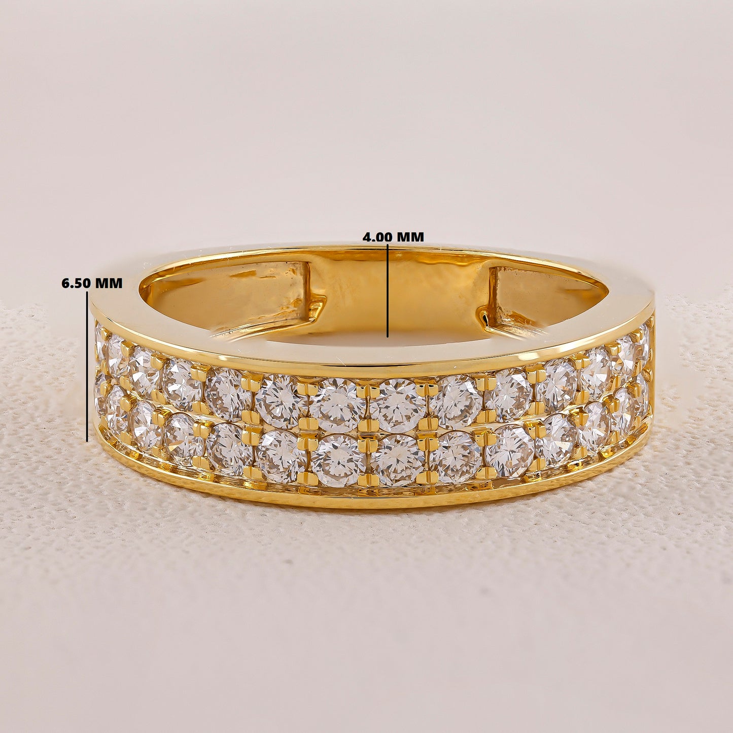 Gold ring with diamond accents on a light gray background