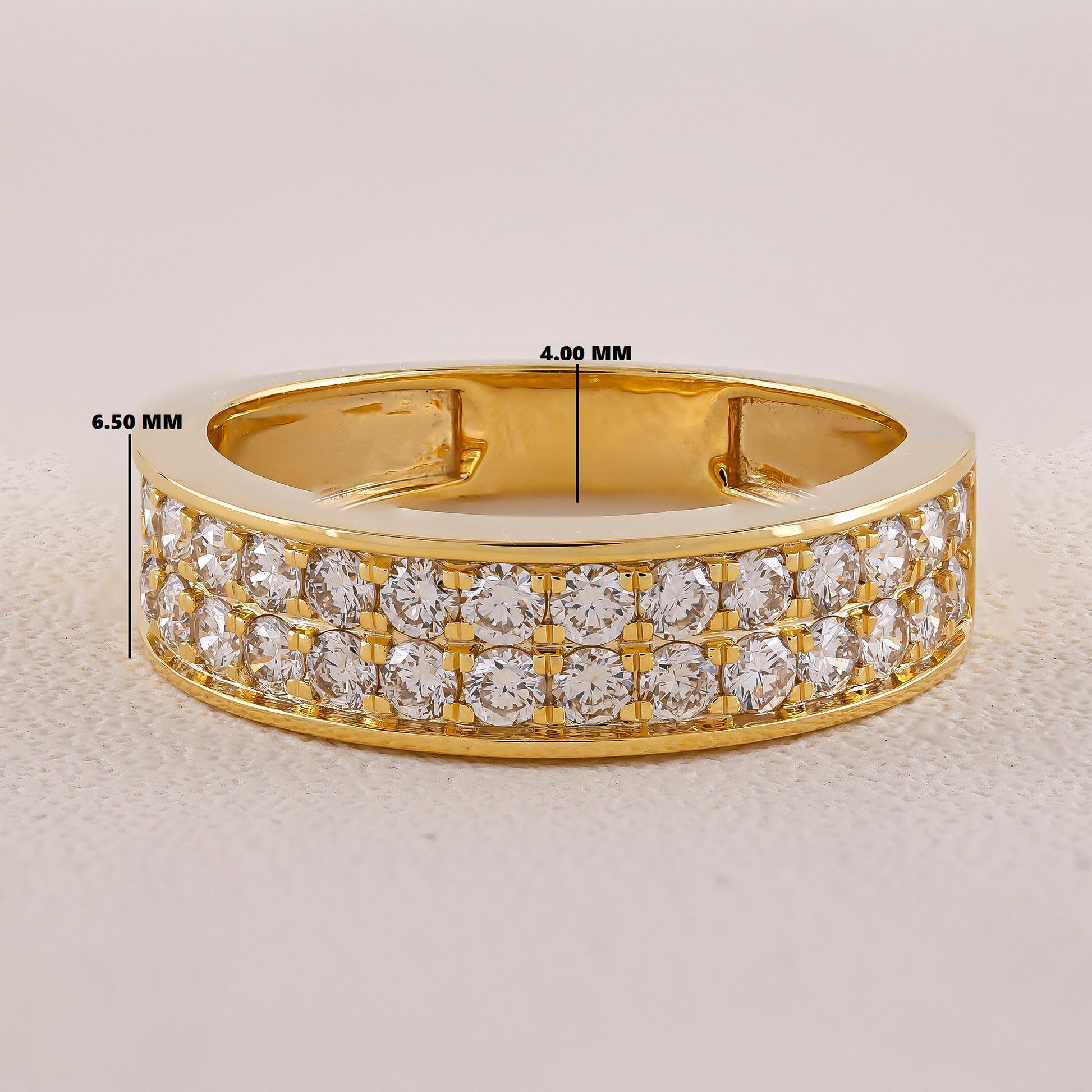 Gold ring with diamond accents on a light gray background