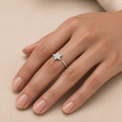 Hand wearing a rose gold ring with diamonds on a beige background