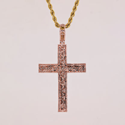 Rose gold cross pendant on a light pink background